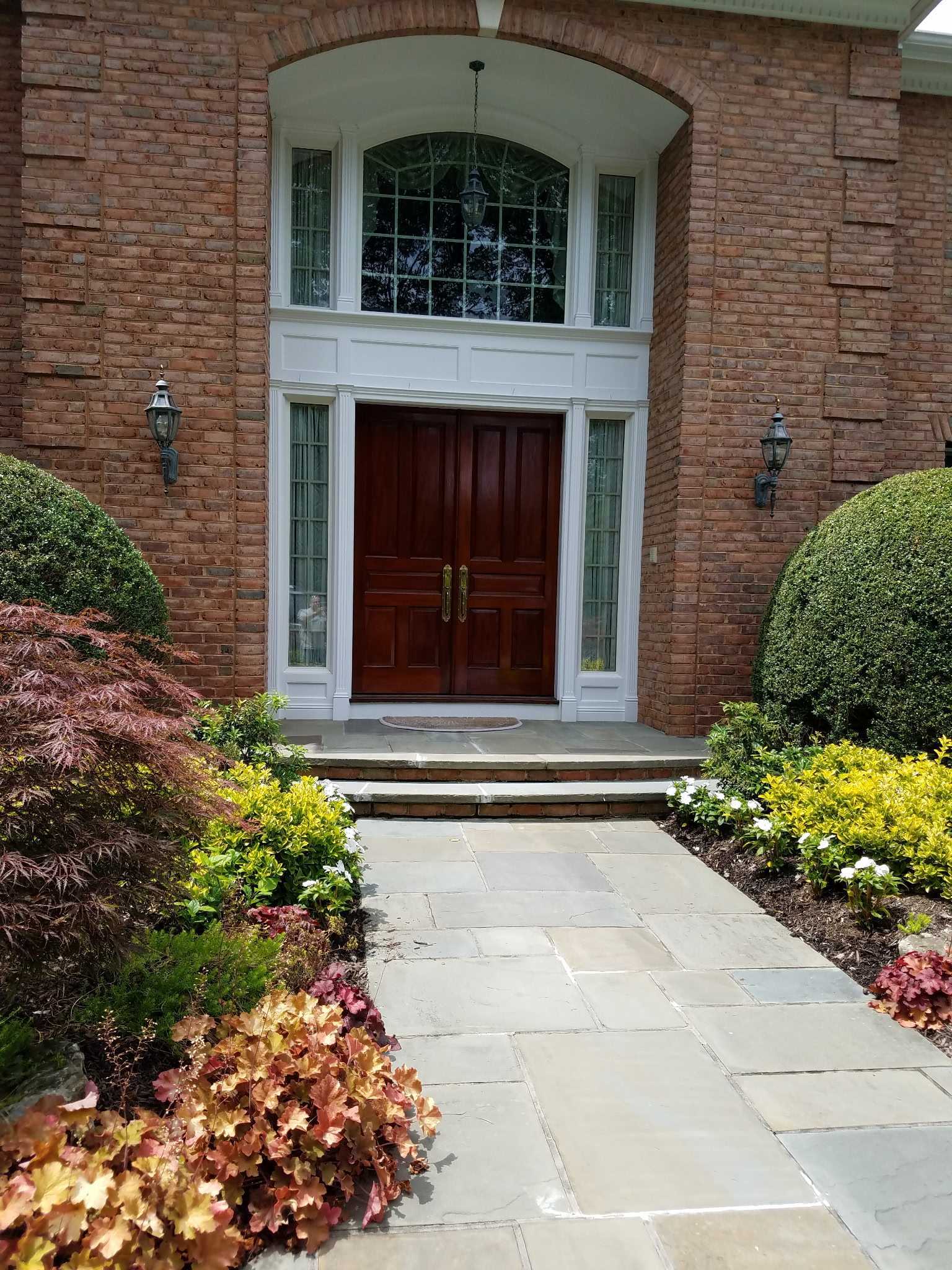 Elegant brick home entrance with custom finishes